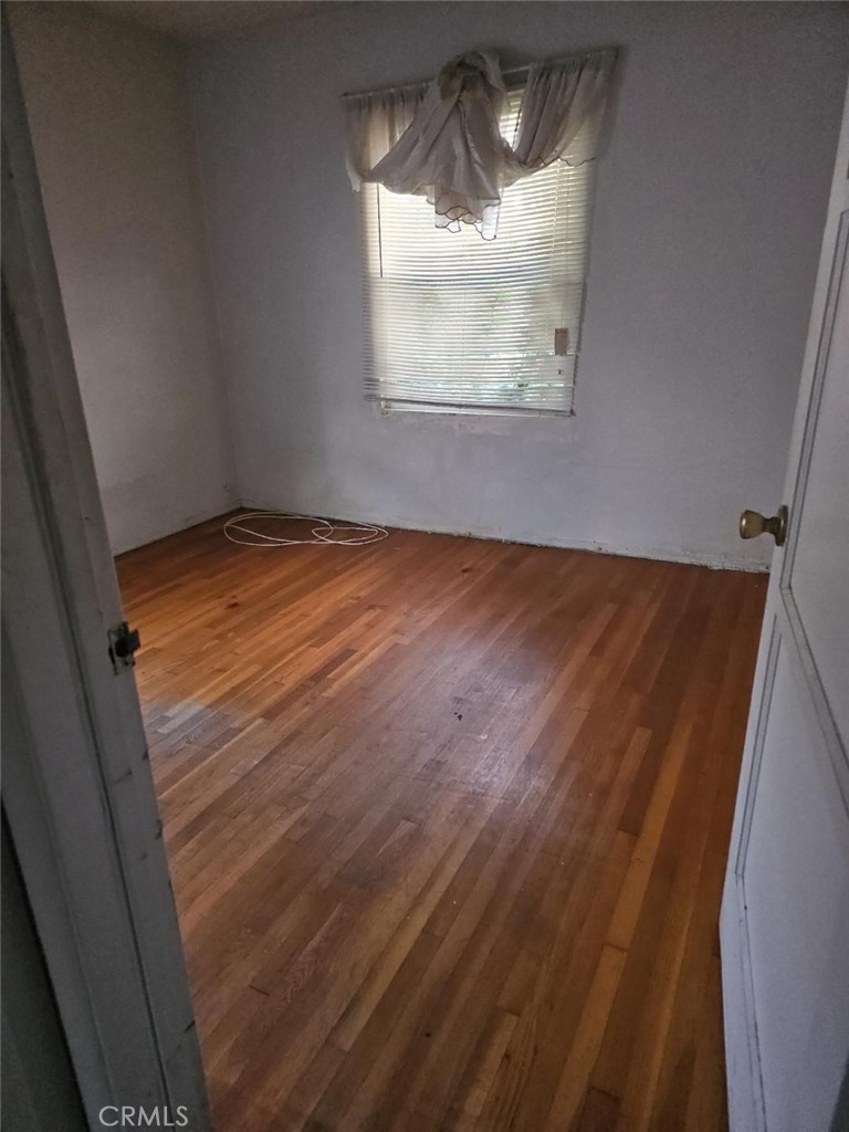 1619 West 136th Street Compton, CA 90222 - Photo 5 of 10 a view of empty room with wooden floor and fan