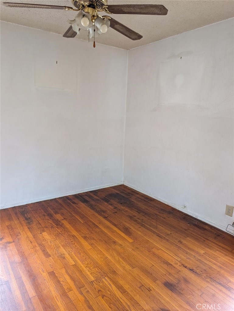 1619 West 136th Street Compton, CA 90222 - Photo 6 of 10 a view of a room with wooden floor and chandelier fan
