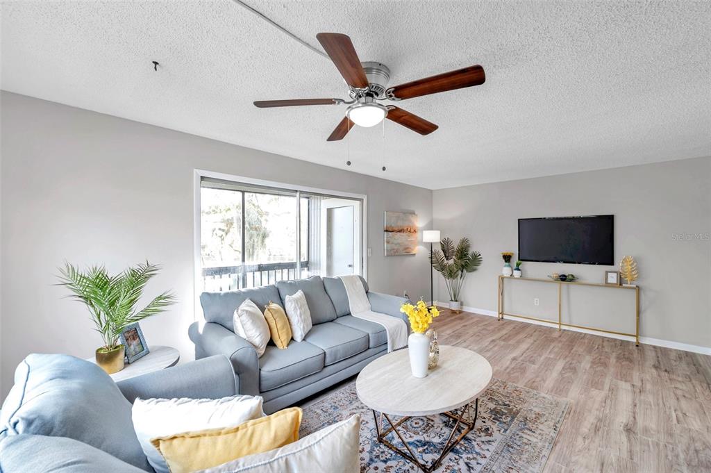 6311 Newtown Circle, Unit 11B1 Tampa, FL 33615 - Photo 12 of 49 a living room with furniture and a flat screen tv