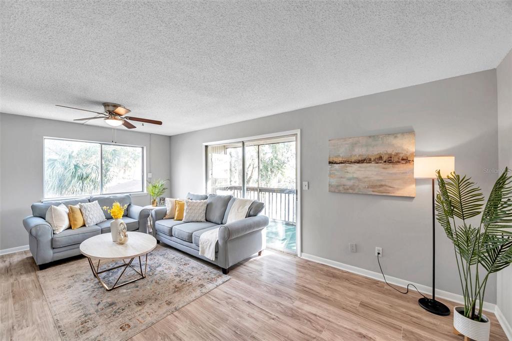 6311 Newtown Circle, Unit 11B1 Tampa, FL 33615 - Photo 13 of 49 a living room with furniture and a large window