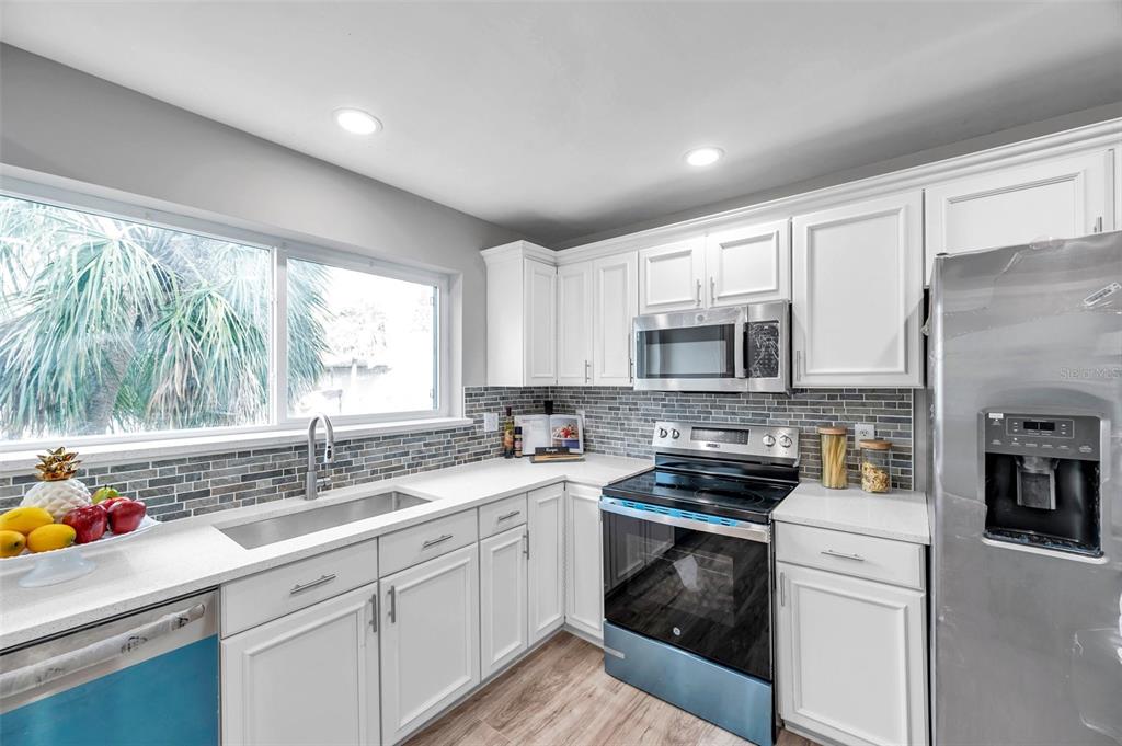 6311 Newtown Circle, Unit 11B1 Tampa, FL 33615 - Photo 17 of 49 a kitchen with a sink stove top oven and refrigerator
