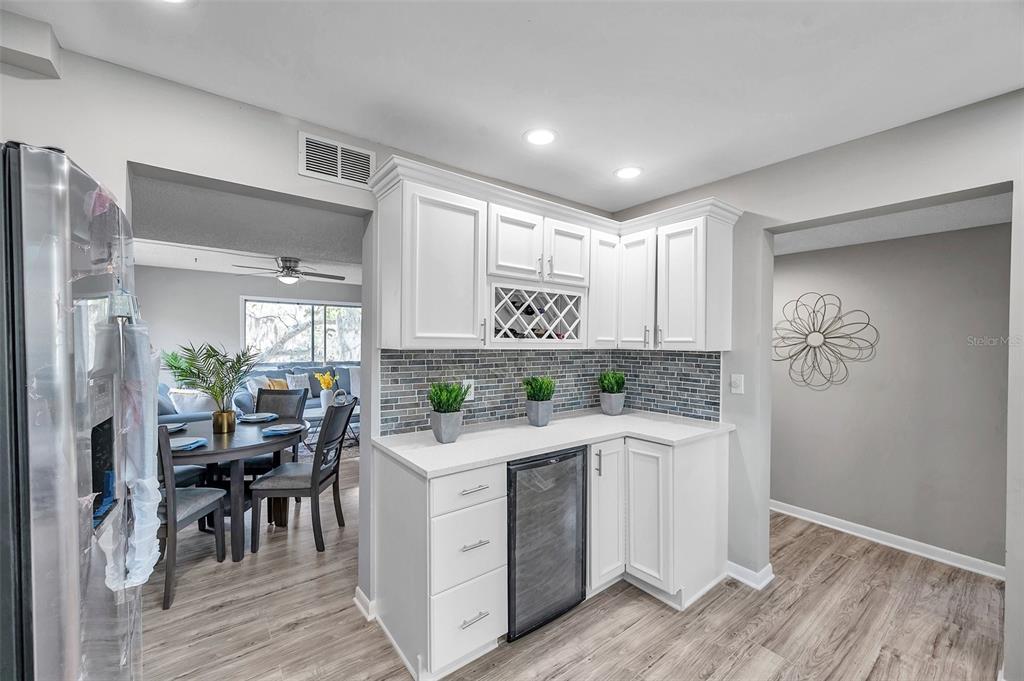 6311 Newtown Circle, Unit 11B1 Tampa, FL 33615 - Photo 20 of 49 a kitchen with a stove a refrigerator and a table