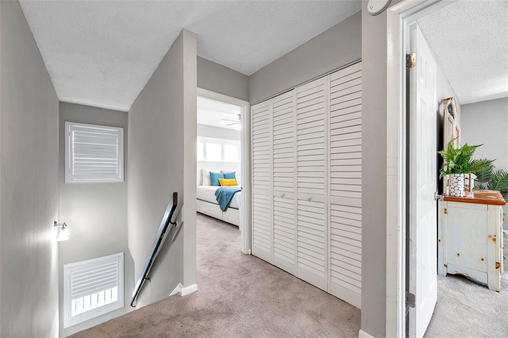 6311 Newtown Circle, Unit 11B1 Tampa, FL 33615 - Photo 22 of 49 a view of a hallway to room with wooden floor and windows