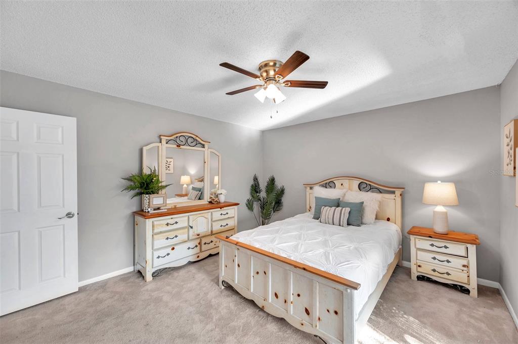 6311 Newtown Circle, Unit 11B1 Tampa, FL 33615 - Photo 25 of 49 a bedroom with a bed and a chandelier