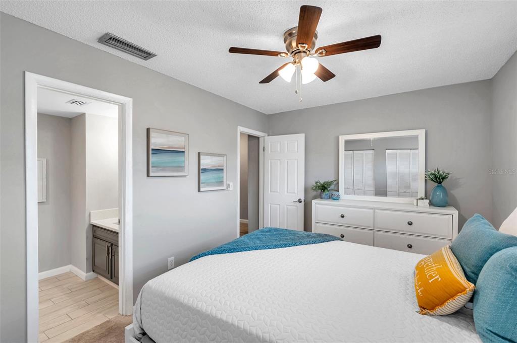 6311 Newtown Circle, Unit 11B1 Tampa, FL 33615 - Photo 33 of 49 a bedroom with a large bed and chandelier