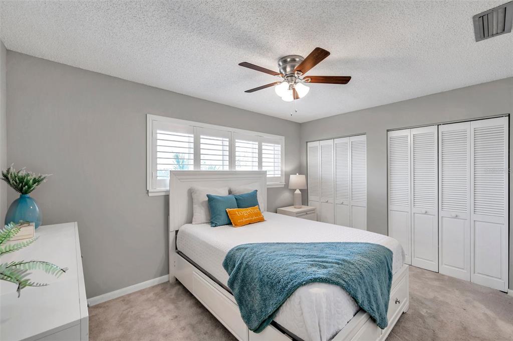 6311 Newtown Circle, Unit 11B1 Tampa, FL 33615 - Photo 34 of 49 a bedroom with a bed and a chandelier