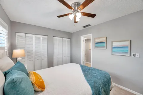a bedroom with a bed and lamp chandelier