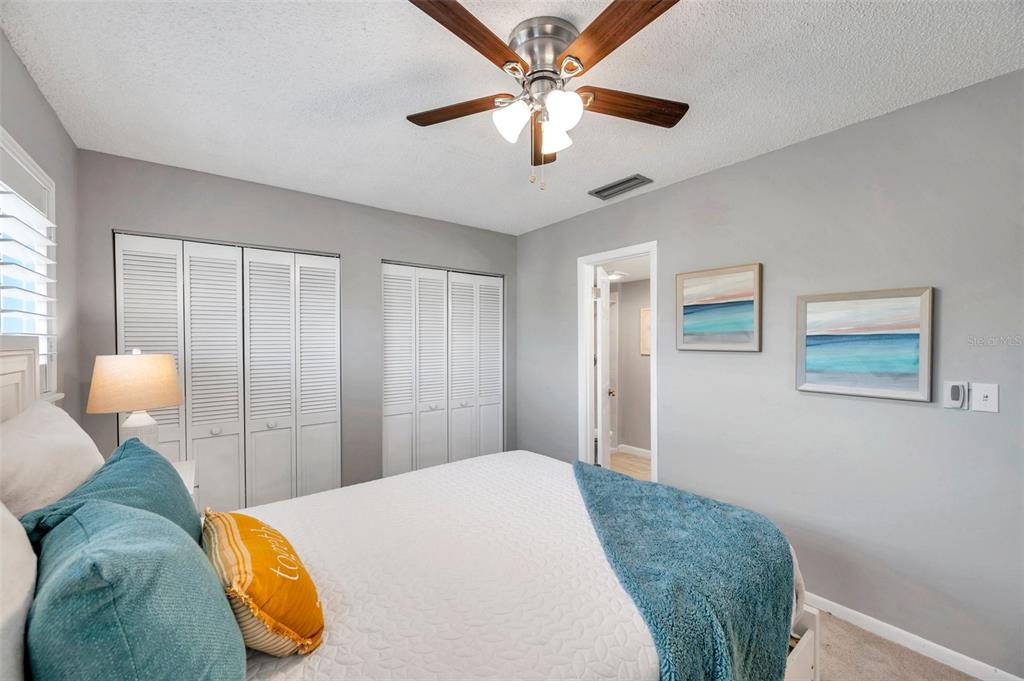 6311 Newtown Circle, Unit 11B1 Tampa, FL 33615 - Photo 35 of 49 a bedroom with a bed and lamp chandelier