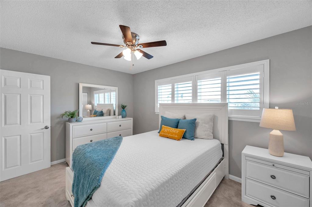 6311 Newtown Circle, Unit 11B1 Tampa, FL 33615 - Photo 36 of 49 a bedroom with a bed and wooden floor