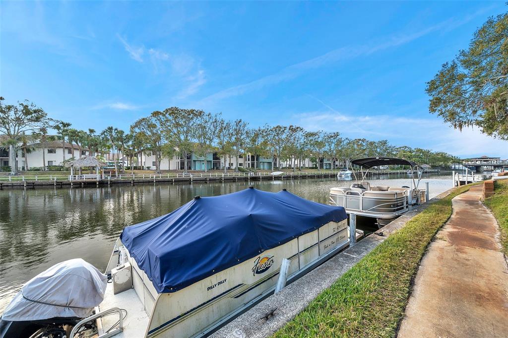 6311 Newtown Circle, Unit 11B1 Tampa, FL 33615 - Photo 44 of 49 a view of a lake with a yard and a wooden fence