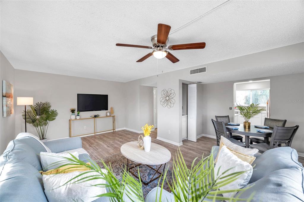 6311 Newtown Circle, Unit 11B1 Tampa, FL 33615 - Photo 10 of 49 a living room with furniture kitchen view and a flat screen tv