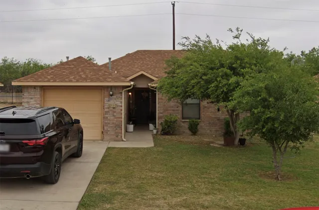 a view of a car park in front of house