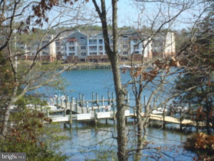 721 Runabout Loop, Unit 721 Solomons, MD 20688 - Photo 2 of 23 a view of swimming pool next to a yard