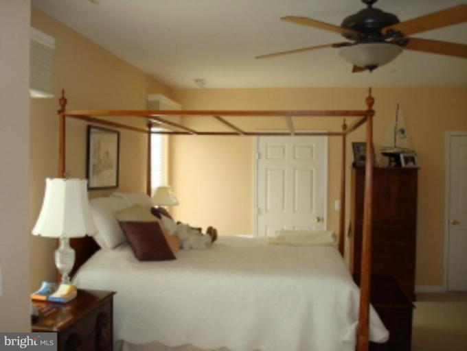 721 Runabout Loop, Unit 721 Solomons, MD 20688 - Photo 11 of 23 a bed room with a bed window and a table
