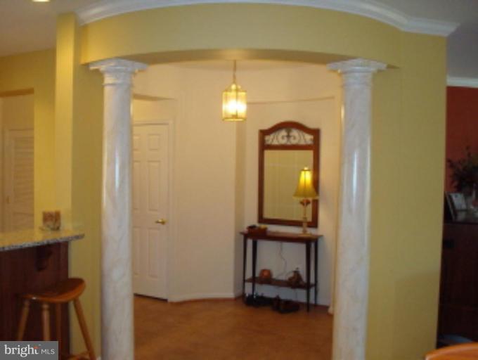 721 Runabout Loop, Unit 721 Solomons, MD 20688 - Photo 12 of 23 a view of a hallway with wooden floor and a livingroom view