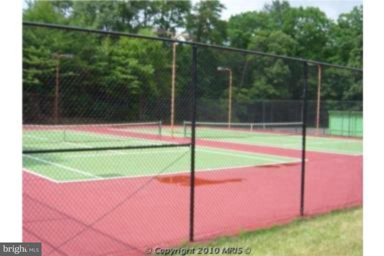 721 Runabout Loop, Unit 721 Solomons, MD 20688 - Photo 16 of 23 a view of a tennis court with a small yard