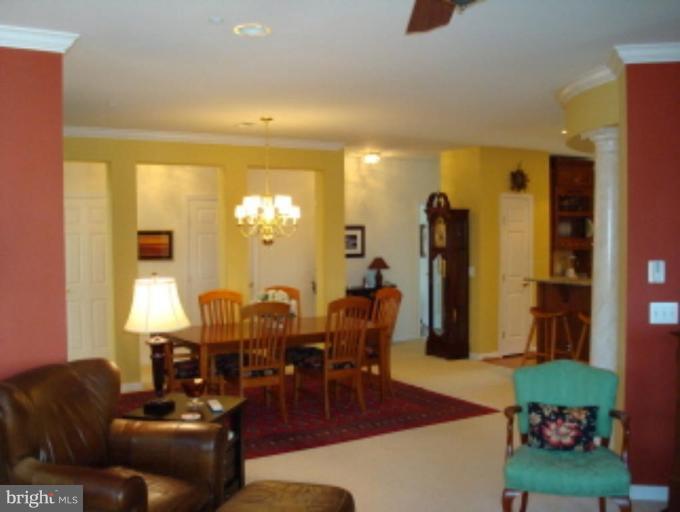 721 Runabout Loop, Unit 721 Solomons, MD 20688 - Photo 3 of 23 a living room with furniture and wooden floor
