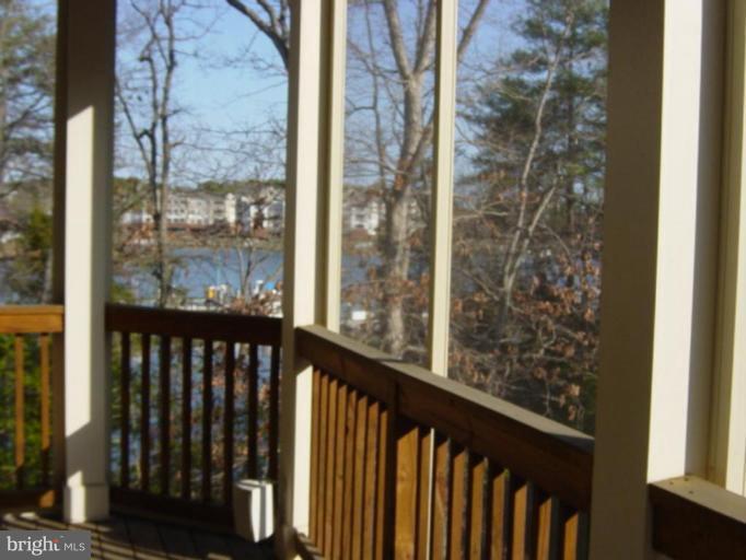 721 Runabout Loop, Unit 721 Solomons, MD 20688 - Photo 22 of 23 a view of a balcony with wooden floor