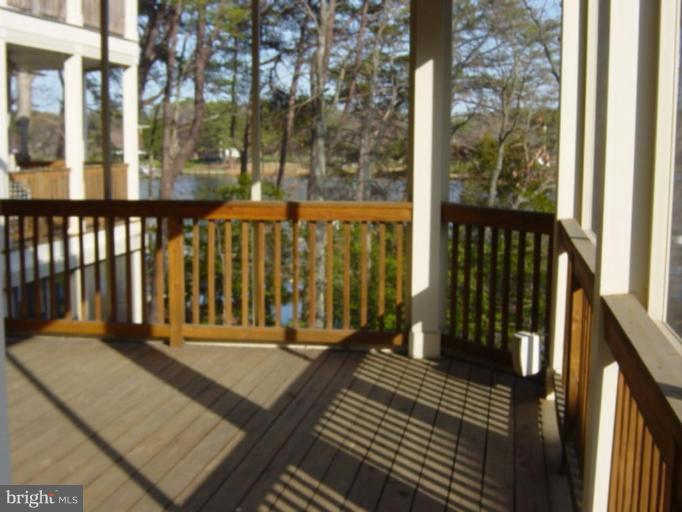 721 Runabout Loop, Unit 721 Solomons, MD 20688 - Photo 23 of 23 a view of a balcony with wooden floor