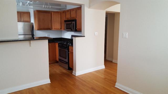 58 Forest Avenue, Unit G Riverside, IL 60546 - Photo 11 of 19 a kitchen with a refrigerator and a stove top oven