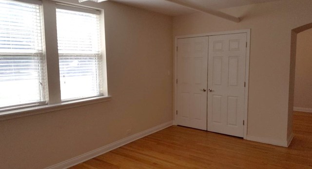 58 Forest Avenue, Unit G Riverside, IL 60546 - Photo 6 of 19 a view of an empty room with wooden floor and a window