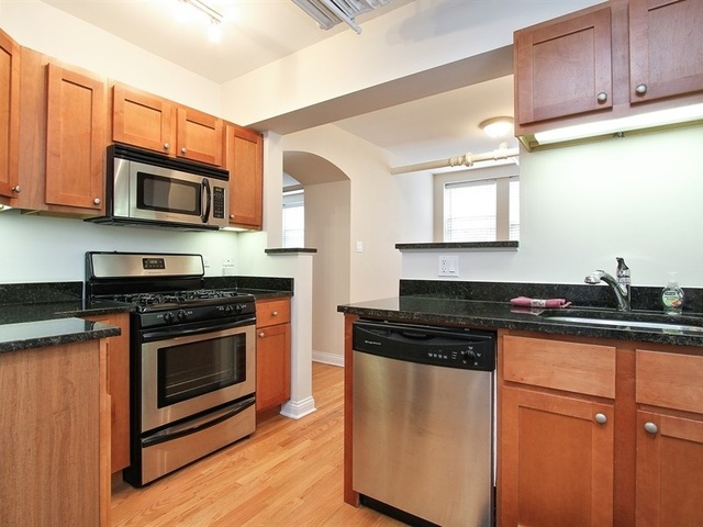 58 Forest Avenue, Unit G Riverside, IL 60546 - Photo 7 of 19 a kitchen with granite countertop wooden cabinets and stainless steel appliances