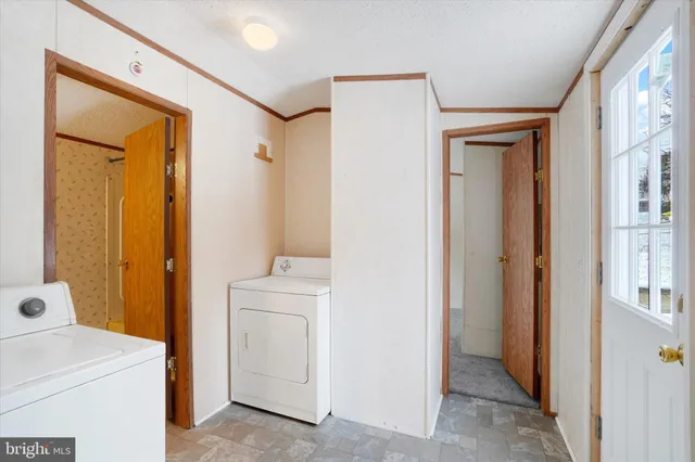 a view of bathroom with a sink a mirror and a washer