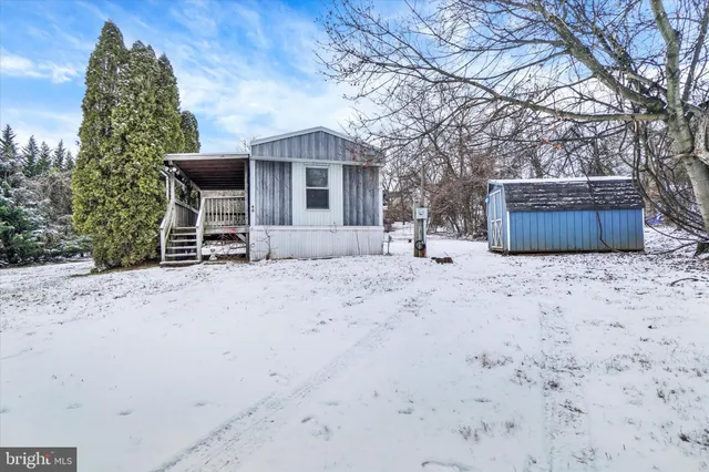 a view of a house with a yard covered in snow