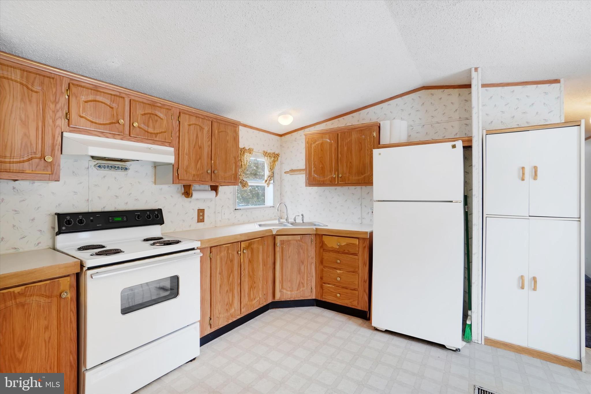 40 Stevens Road Etters, PA 17319 - Photo 8 of 19 a kitchen with white cabinets and white appliances