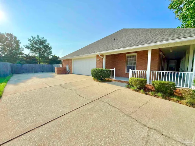 a view of a backyard with wooden fence