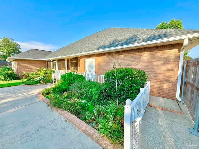 a front view of a house with garden