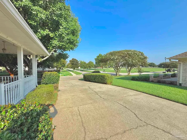 a view of backyard of house with green space