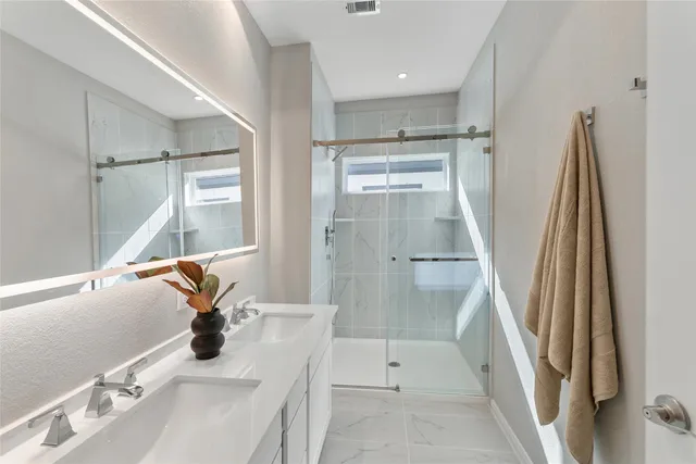 a bathroom with a sink a mirror and a bathtub