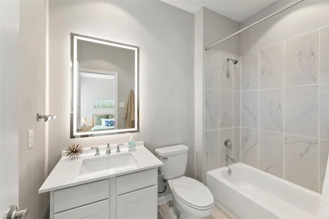 a bathroom with a sink toilet vanity and shower