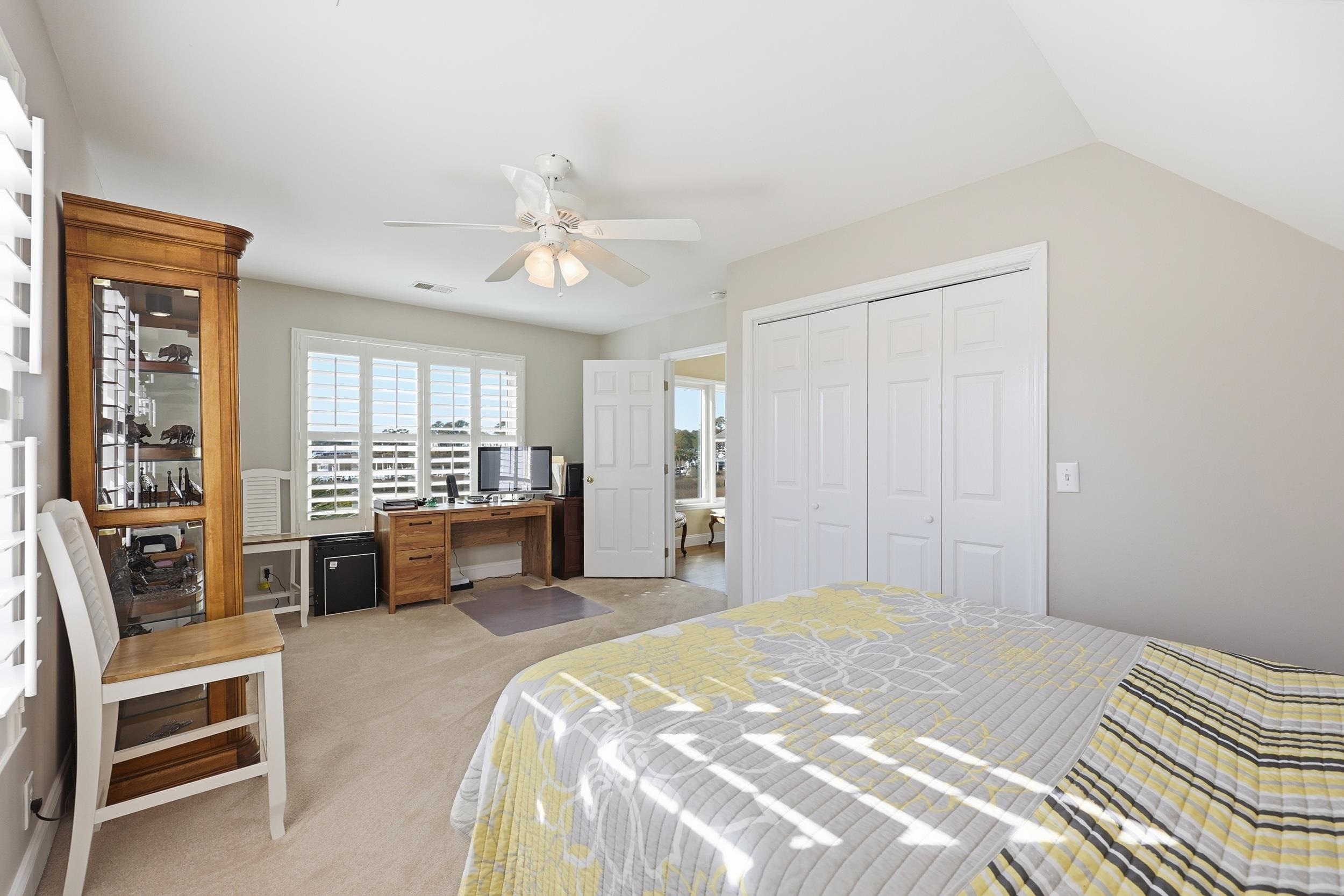 4524 Landing Road Little River, SC 29566 - Photo 21 of 40 Bedroom featuring light carpet, a desk, a closet, and ceiling fan
