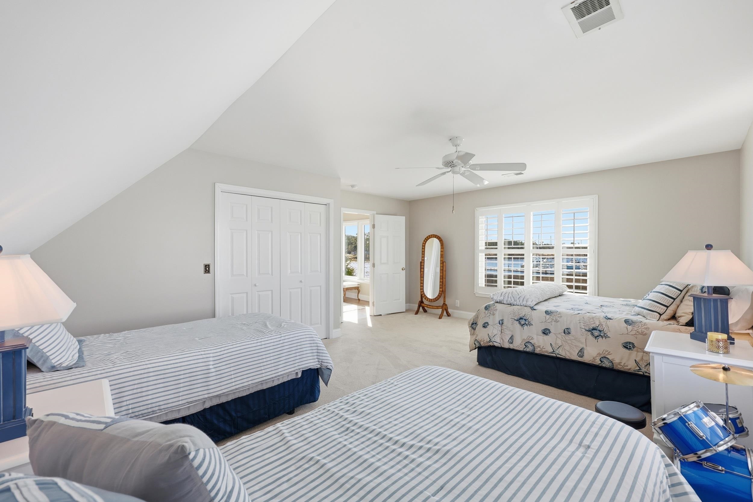 4524 Landing Road Little River, SC 29566 - Photo 25 of 40 Carpeted bedroom with a closet, ceiling fan, and connected bathroom