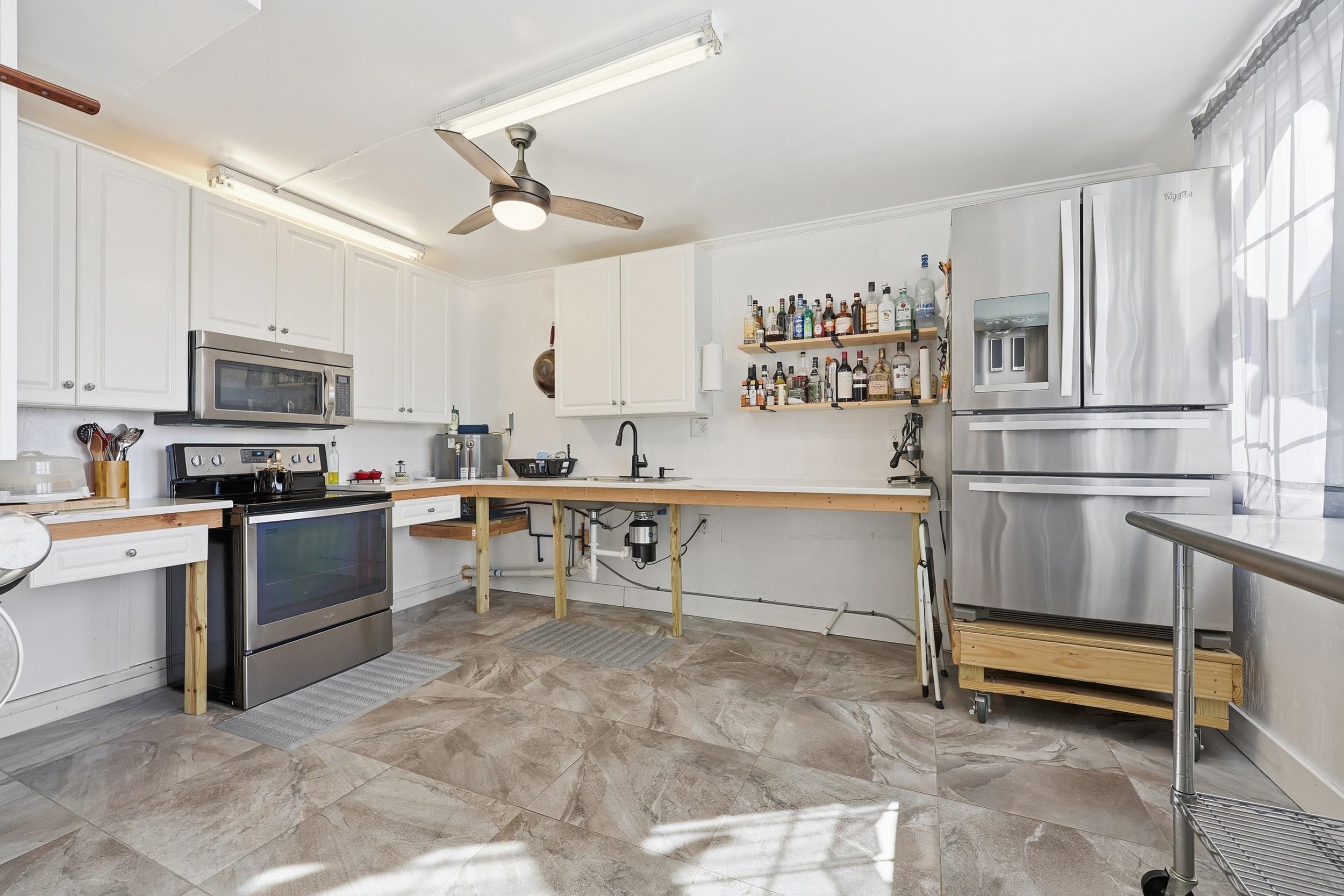 4524 Landing Road Little River, SC 29566 - Photo 26 of 40 Kitchen with stainless steel appliances, white cabinets, a ceiling fan, and open shelves