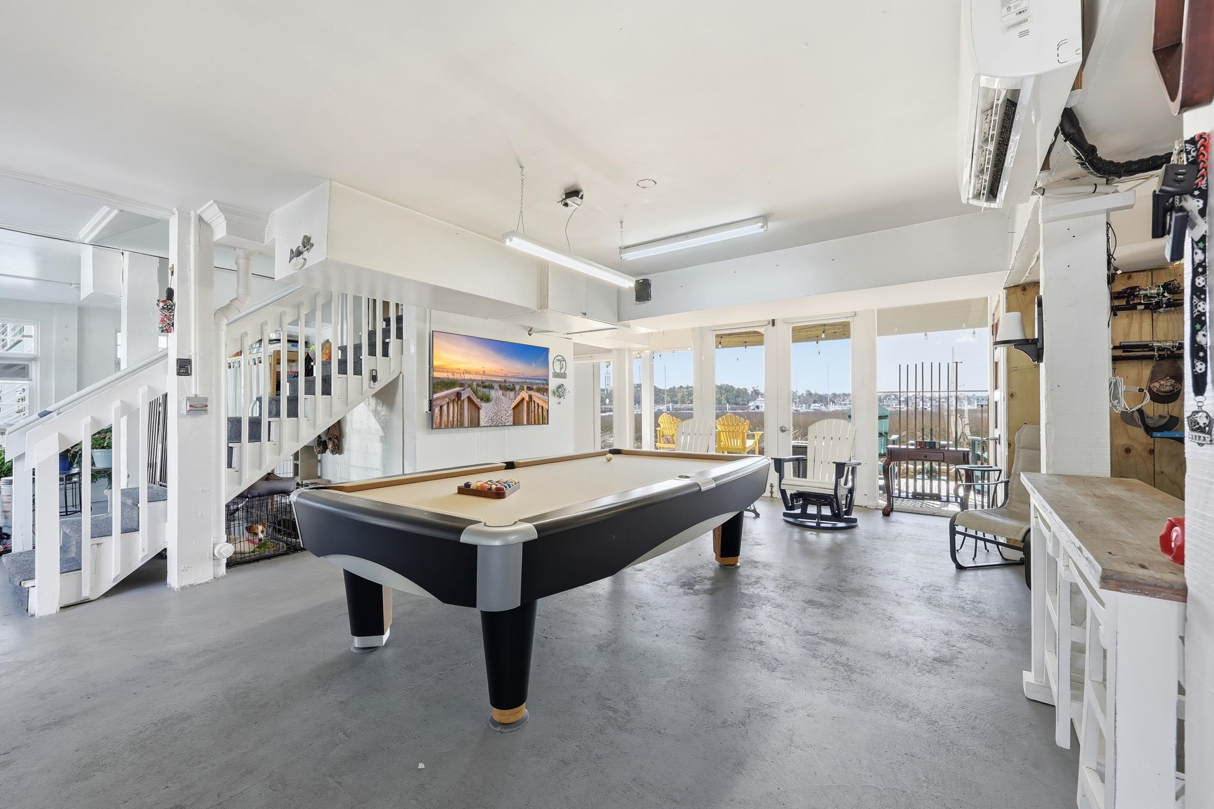 4524 Landing Road Little River, SC 29566 - Photo 28 of 40 Playroom with finished concrete floors, billiards table, and french doors