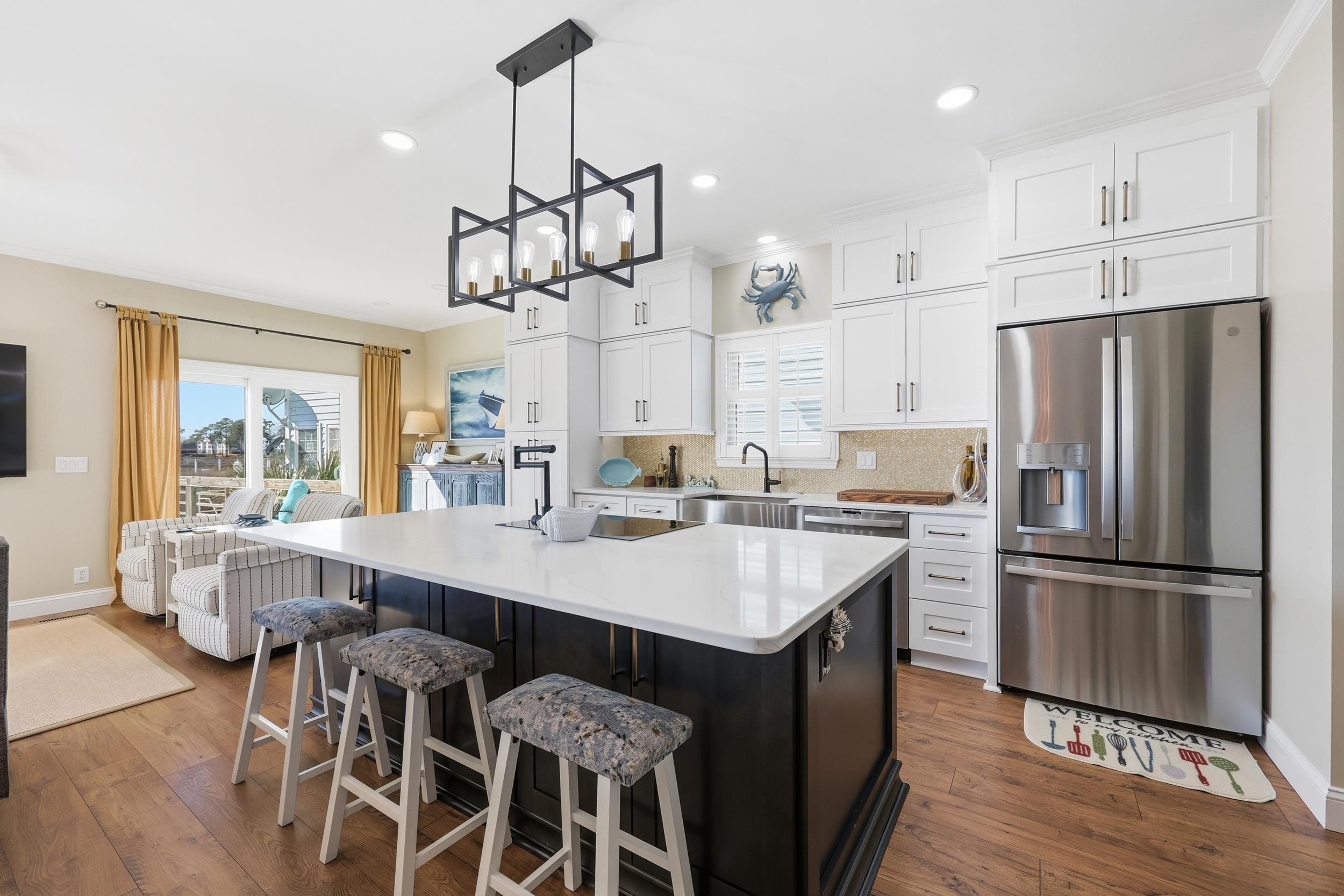 4524 Landing Road Little River, SC 29566 - Photo 8 of 40 Kitchen featuring stainless steel appliances, white cabinets, pendant lighting, a center island, and ornamental molding