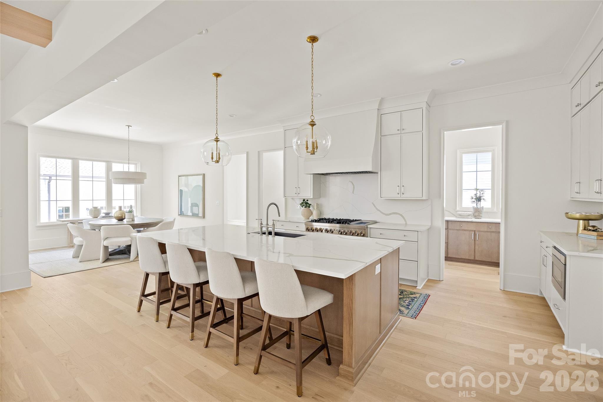4628 Water Oak Road Charlotte, NC 28211 - Photo 11 of 43 a large kitchen with kitchen island a sink table and chairs