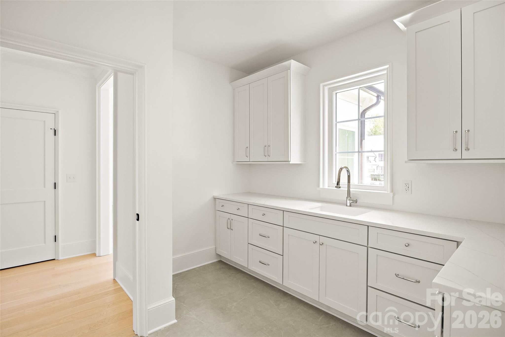 4628 Water Oak Road Charlotte, NC 28211 - Photo 30 of 43 a kitchen with white cabinets and a sink