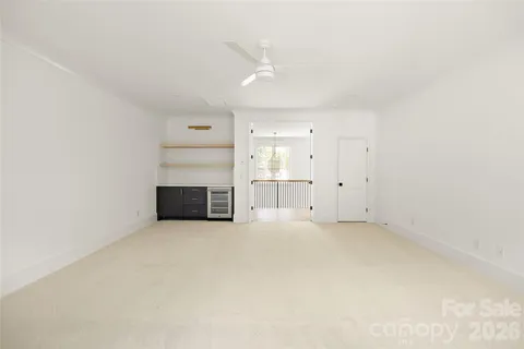 an empty room with wooden floor and a window