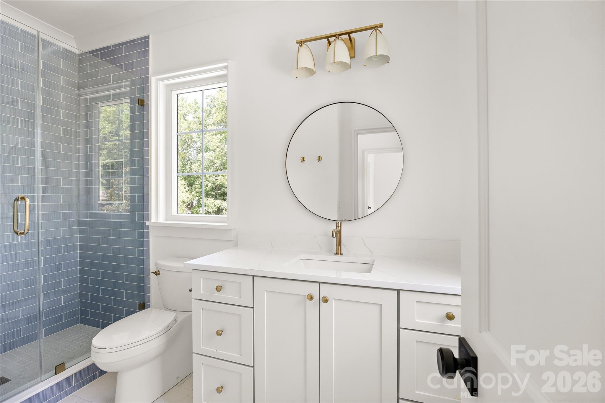 4628 Water Oak Road Charlotte, NC 28211 - Photo 35 of 43 a bathroom with a toilet a sink and a mirror