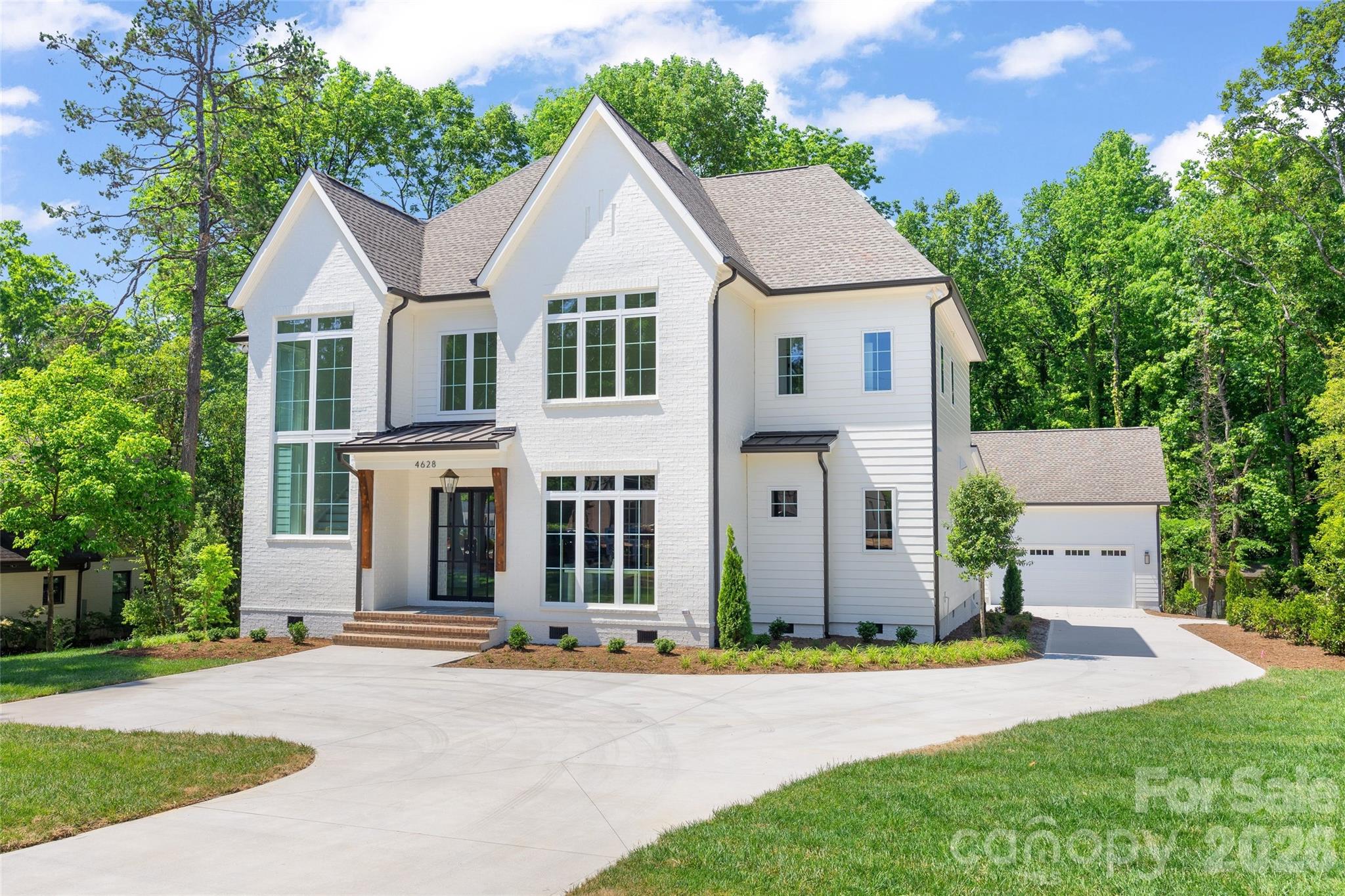 4628 Water Oak Road Charlotte, NC 28211 - Photo 6 of 43 a front view of a house with a yard and garage