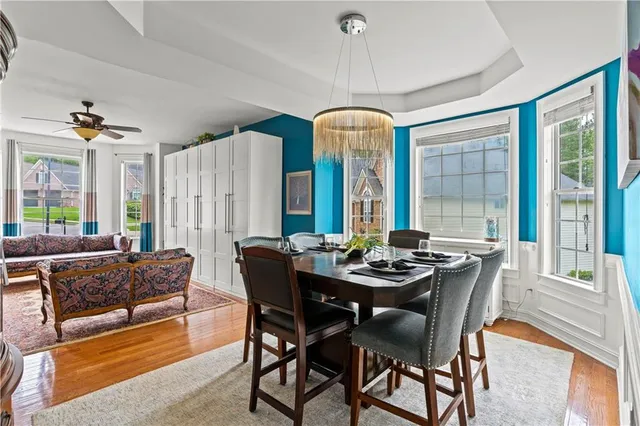 a view of a dining room with furniture and chandelier