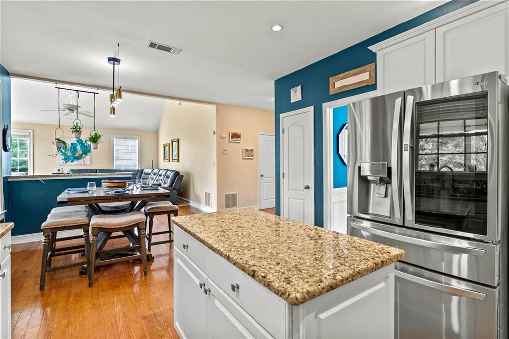 638 Glen Valley Way Dacula, GA 30019 - Photo 14 of 61 a kitchen that has a kitchen island wooden cabinets and stainless steel appliances