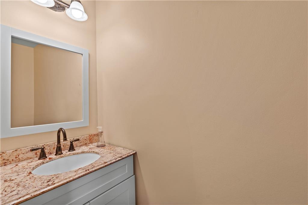 638 Glen Valley Way Dacula, GA 30019 - Photo 24 of 61 a bathroom with a granite countertop sink and a mirror