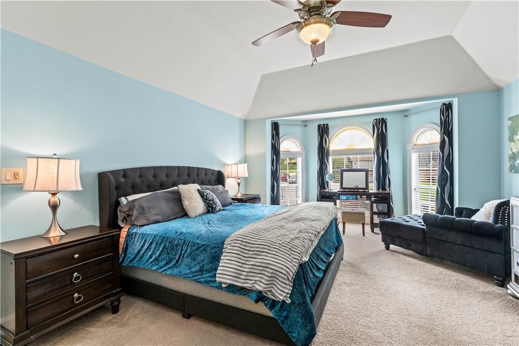 638 Glen Valley Way Dacula, GA 30019 - Photo 30 of 61 a bedroom with a bed and a couch