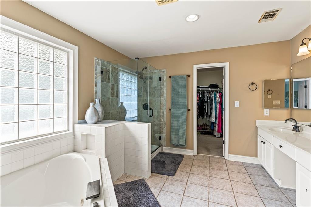 638 Glen Valley Way Dacula, GA 30019 - Photo 32 of 61 a spacious bathroom with a bathtub and a sink
