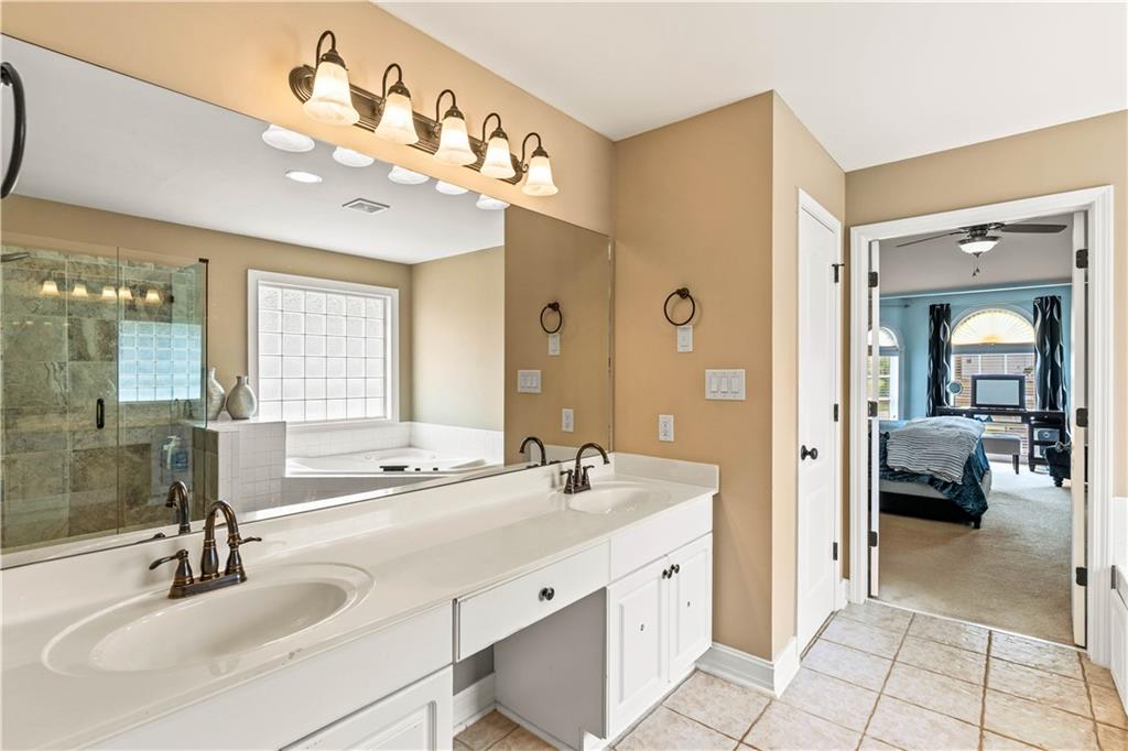 638 Glen Valley Way Dacula, GA 30019 - Photo 33 of 61 a spacious en suite bathroom with a double vanity sink a mirror and a shower